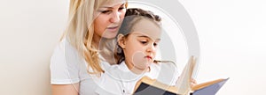 Mother and daughter doing homework at home