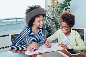 Mother and daughter doing homework learning to calculate