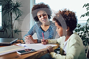 Mother and daughter doing homework learning to calculate