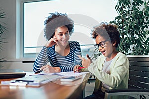 Mother and daughter doing homework learning to calculate