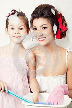 Mother And Daughter Doing Laundry