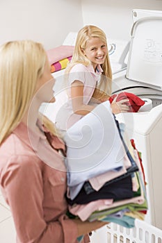 Mother And Daughter Doing Laundry