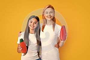 Mother and daughter doing morning hair care. Smiling mom and kid in show clean mockup shampoo, conditioner or face wash