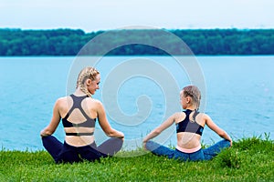 Mother and daughter doing yoga exercises