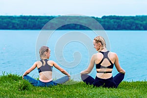 Mother and daughter doing yoga exercises