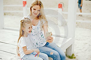 Mother with daughter drawing in a park