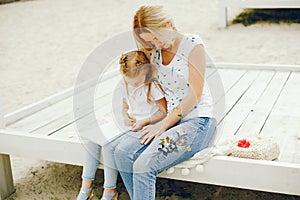 Mother with daughter drawing in a park