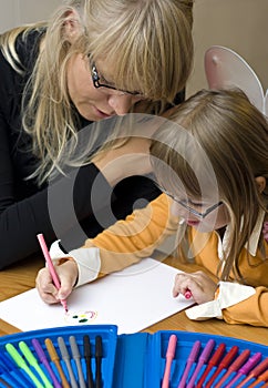 Mother and daughter drawing together photo