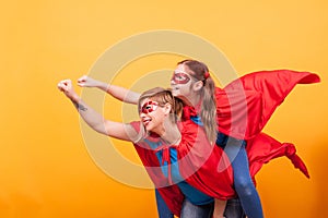 Mother and daughter dressed like superheros flying off save the world from villans