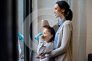 Mother and daughter drinking hot beverage