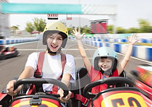 Mother and daughter driving go kart on the track