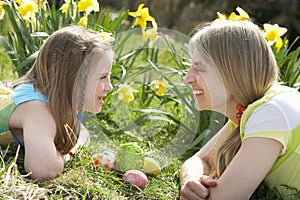 Mother And Daughter On Easter Egg Hunt