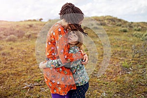 Mother and daughter embracing outdoors photo