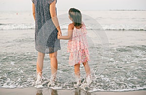 Mother and daughter enjoy together at sunet on the beach
