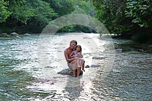 Mother and daughter enjoy the view of the Acheron river with its pristine nature in Epirus, Greece