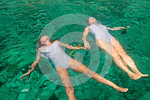 Mother and daughter enjoying summer at Zakynthos island in Greece wearing the same swimsuit.