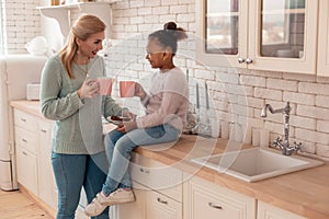 Mother and daughter enjoying weekend spending morning together