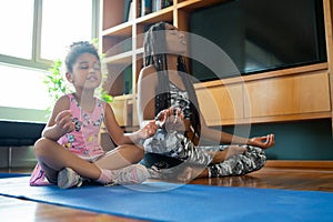 Mother and daughter exercising together at home. photo