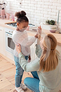 Mother and daughter feeling happy after cooking breakfast together