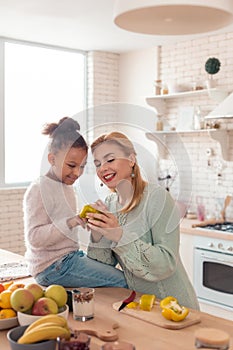 Mother and daughter feeling involved in cooking dinner