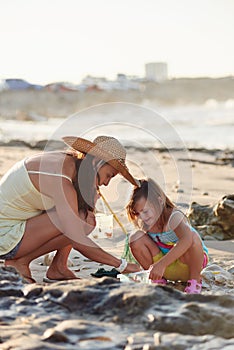 Mother daughter fishing beach