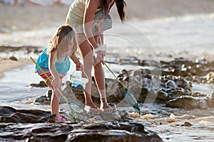 Mother daughter fishing beach