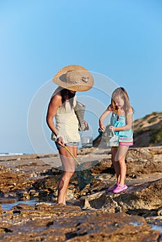 Mother daughter fishing beach