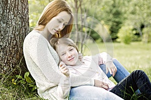 Mother and daughter in forest together