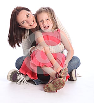 Mother daughter fun and laughter sitting on floor photo