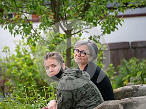 Mother and daughter in the garden during pandemics