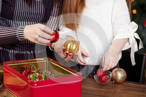 Mother and daughter geting Christmas toys out of box. Christmas and new year concept.  Christmas decor. Happy family