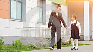 Mother and daughter go home from modern primary school