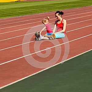 Mother and daughter go in for sports at the stadium.