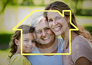 Mother, daughter and grandmother smiling together in the park with house outline