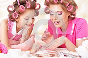 Mother and daughter in hair curlers