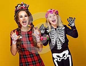 Mother and daughter in halloween costume frightening