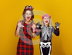 Mother and daughter in halloween costume frightening