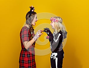 Mother and daughter in halloween costume frightening each other