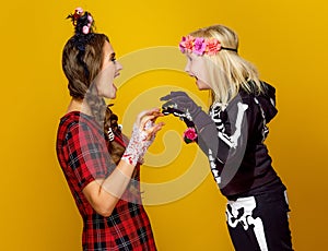 Mother and daughter in halloween costume frightening each other