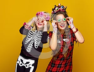 Mother and daughter in halloween costume having fun time