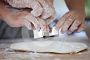 Mother and daughter hands prepare a dough for baking cookies