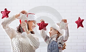 Mother and daughter hang a garland