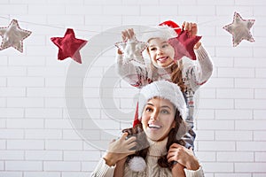 Mother and daughter hang a garland