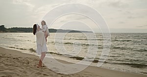 Mother and daughter have fun playing and fooling around on the beach together