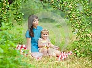 Mother and daughter have picnic outdoor