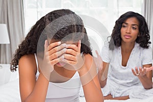 Mother and daughter having an argument on bed