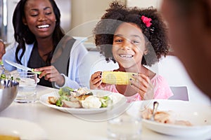 Mother And Daughter Having Family Meal At Table