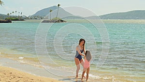 Mother and daughter having fun at the beach 4k