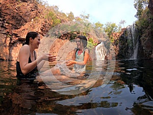 Mother and daughter having fun in Florence Falls  Northern Territory Australia