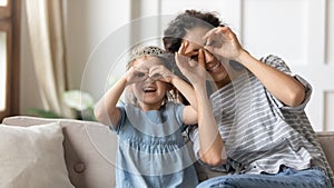 Mother and daughter having fun make with fingers eyewear shape